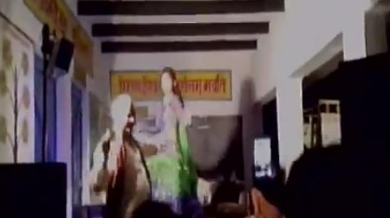 The video of the same has gone viral, and also shows the village heads trying to match their steps with the dancers as well as showering money on girls. (Photo: screengrab)