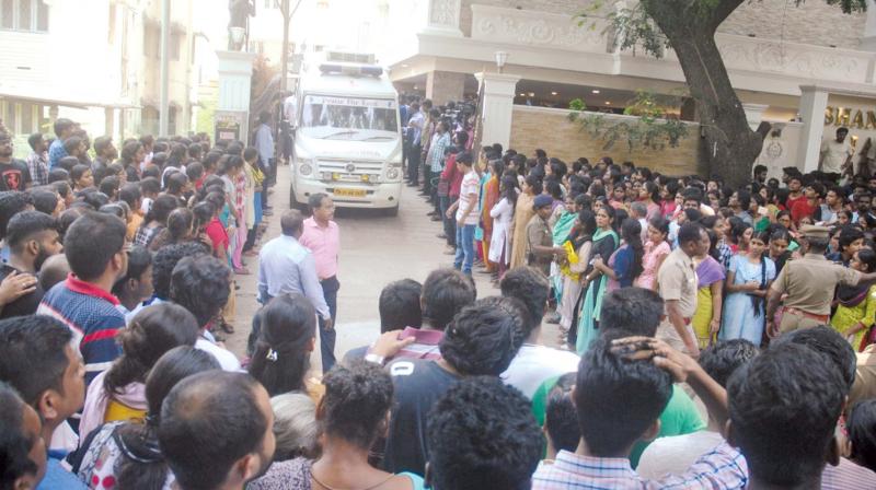 Hundreds of civil service aspirants looking at the  ambulance carrying the mortal remains of D.Shankaran, as it comes out of the Shankar IAS Academy premises after being kept there for public homage in Anna Nagar on Friday. (Photo: DC)