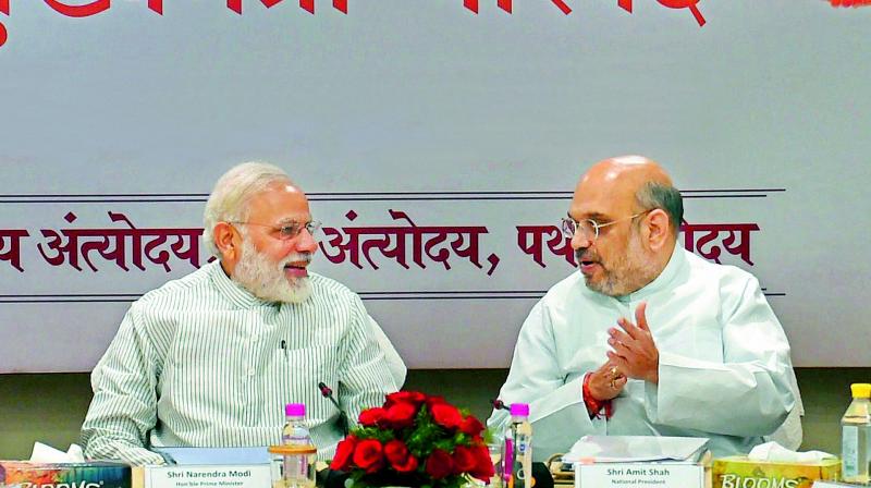 Prime Minister Narendra Modi with BJP president Amit Shah during a meeting with  BJP chief ministers at the party office in New Delhi on Sunday. The BJPs top brass deliberated on the vision for a New India. (Photo: PTI)