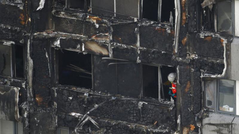 A massive fire ripped through a 27-storey apartment block in west London in the early hours of Wednesday, trapping residents inside as 200 firefighters battled the blaze.