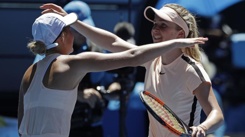 Ukraines Elina Svitolina, right, is embraced by compatriot Marta Kostyuk after winning their third round. (Photo: AP)