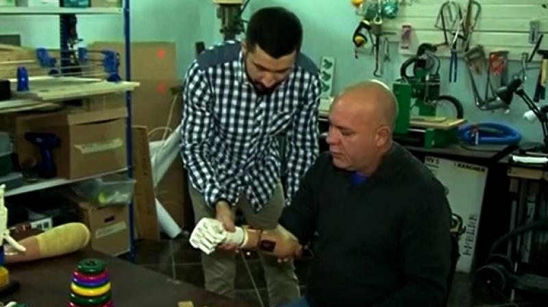 Almost three decades later the 53-year-old Belarussian became the first tester of a prosthetic arm designed and made by his own son (Photo: YouTube)