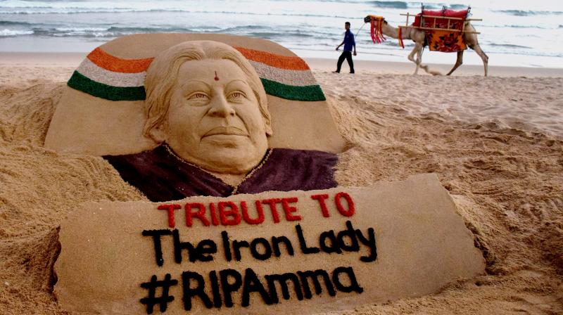 Sand artist Sudarshan Pattanaik creates a sand art to pay tribute to J Jayalalithaa at Puri beach. (Photo: PTI)