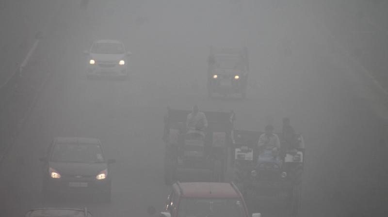 Vehicles move through dense fog at Delhi- Agra Highway in Faridabad. (Photo: PTI)