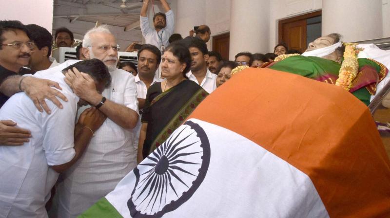 Prime Minister Narendra Modi consoles O Panneerselvam while pays his last respects to Tamil Nadus former Chief Minister Jayaram Jayalalithaa at Rajaji Hall in Chennai. (Photo: PTI)