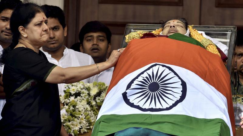 Sasikala, the close aide of Tamil Nadus former Chief Minister Jayaram Jayalalithaa near her mortal remains kept at Rajaji Hall for public viewing in Chennai. (Photo: PTI)