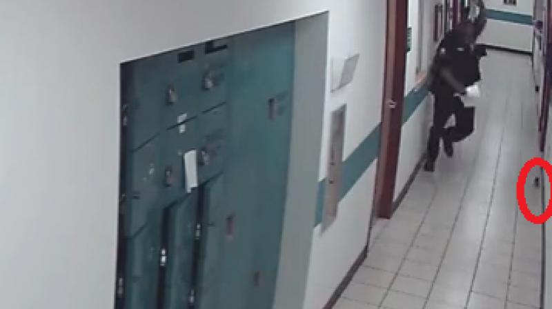 The video posted on Youtube is a CCTV footage grab of the St Petersburg Police Department in Florida where the police officer is busy getting his work done. (Photo: Youtube)