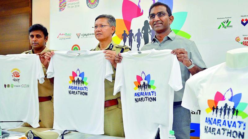 Commissioner of Police D. Gautam Sawang, Marathon director Murali Nannapaneni and DCP Kanthi Rana Tata release Amaravati Marathon T Shirts in Vijayawada on Tuesday. (Photo: DC)