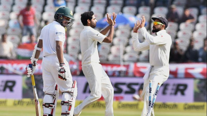 Virat Kohli and Bhuvneshwar Kumar celebrate a Bangladesh wicket (Photo: PTI)