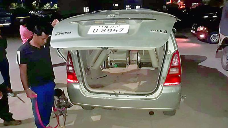 RSASTF sleuths with the help of sniffer dog checking a vehicle, which was found to be used for the smuggling, and was parked at TTDs Srinivasam complex in Tirupati.