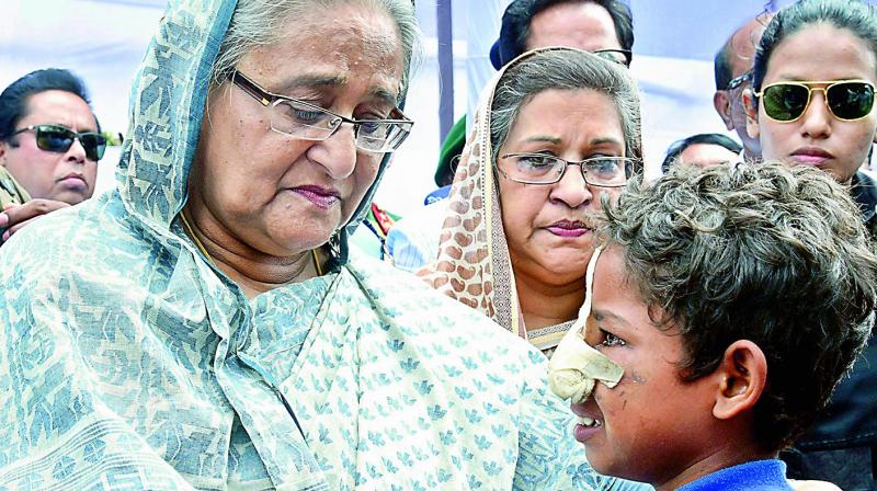 Bangladeshi Prime Minister Sheikh Hasina meets a Rohingya Muslim child at Kutupalong refugee camp in Bangladesh on Tuesday. (Photo: AP)