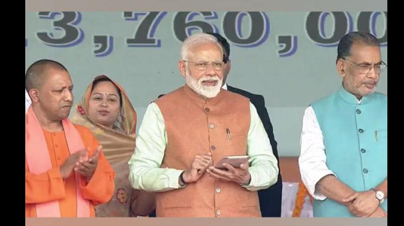 After launching the scheme, the Prime Minister also handed over certificates to select beneficiaries of the scheme. (Photo: ANI)
