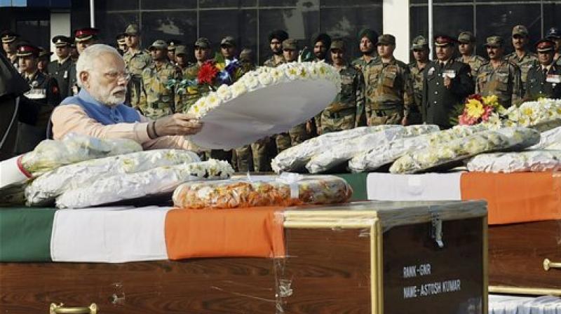 Prime Minister Narendra Modi pays tribute to security personnel who lost their lives in encounters with terrorists in J&K on tuesday, at AFS Palam in New Delhi. (Photo: AP)