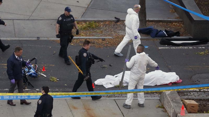 Authorities investigate the scene near a covered body on a bike path after a motorist drove onto the path near the World Trade Center memorial, striking and killing several people in New York. (Photo: AP)