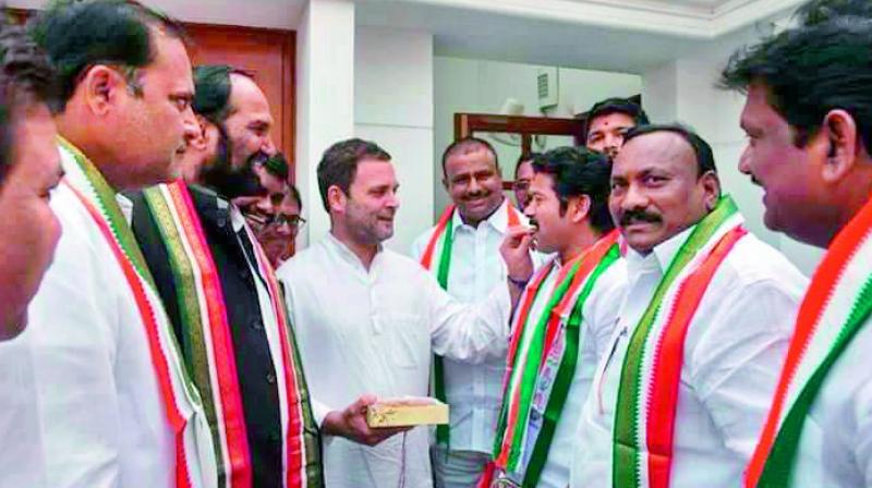 Congress vice-president Rahul Gandhi welcomes A. Revanth Reddy to the party fold with sweets, at his residence in New Delhi on Tuesday. (Photo: DC)