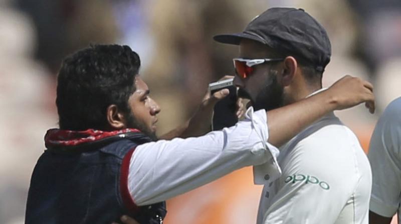 A case of trespassing was slapped against 19-year-old Mohammad Khan, who breached security cordon to get up close with Virat Kohli on Day 1 of the second India versus West Indies Test in Hyderabad. (Photo: AP)
