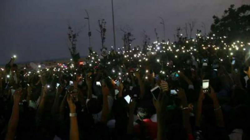 Images of people sleeping at the Marina beach on the first night of the protest, and the now iconic image of youngsters flashing their phone lights, were shared and re-shared with religious reverence. (Photo: Twitter)