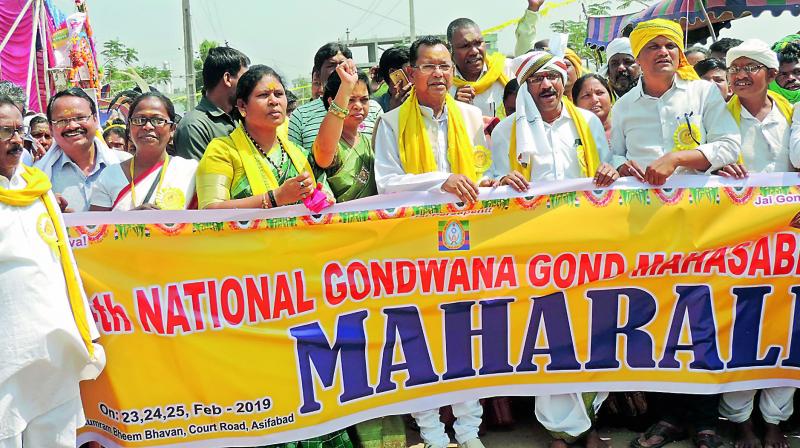 Adivasis take out a rally as part of 14th National Gondawana Gond Mahasabha. They performed puja at the Katamraju temple in Asifabad town on Sunday. 	 DC
