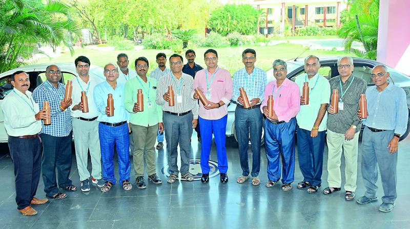 Staff members of KITS, Warangal with the copper water bottles. 	 DC