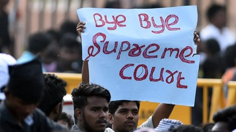 Youngsters and students during the protest to lift ban on jallikattu and impose ban on PETA, at Kamarajar Salai, Marina Beach in Chennai on Saturday. (Photo: PTI)