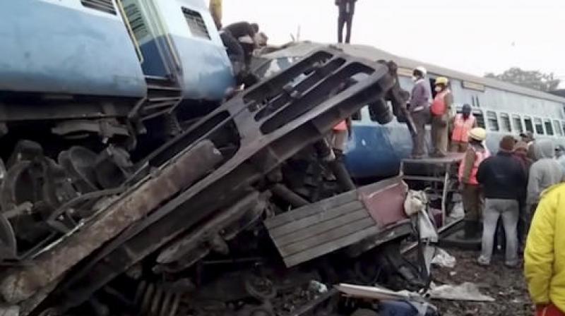 In this image from video, rescuers stand around coaches of a derailed passenger train in Kuneru, Andhra Pradesh. (Photo: AP)