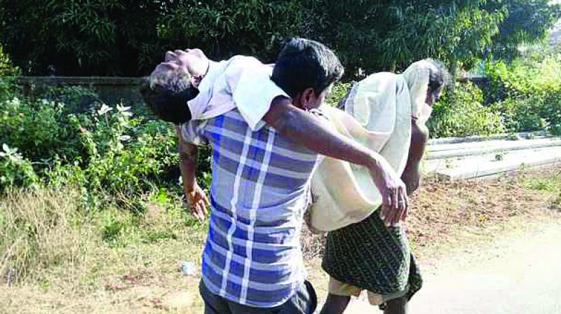 Sarat Barik of Kothasahi village in Odisha carries his fathers body on his shoulders due to the unavailability of hearse at the local health centre.