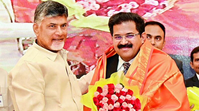 Chief Minister N. Chandrababu Naidu felicitates Krishna district collector A. Babu during the collectorsconference in Vijayawad on Thursday. (Photo: DECCAN CHRONICLE)