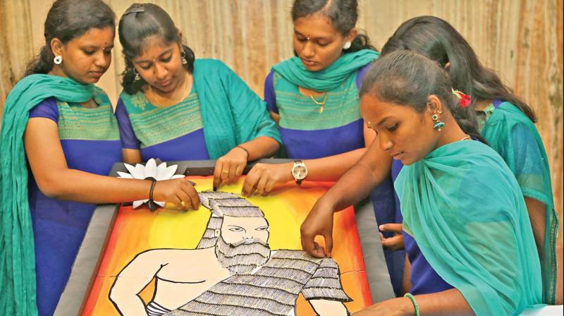 Five Coimbatore-based college students create an art work of saint Tiruvalluvar to commemorate Tiruvalluvar Day observed on Monday.  The team of girls used match sticks to write the 1,330 couplets. (Photo: DC)