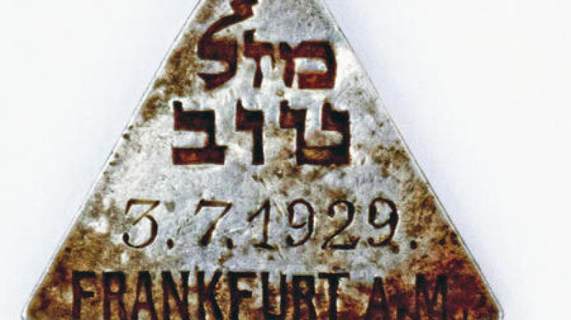 This undated photograph released by the Israel Antiquities Authority shows a pendant that appears identical to one belonging to Anne Frank, Israels Yad Vashem Holocaust memorial. (Photo: AP)