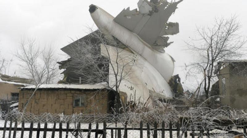 The tail of a crashed Turkish Boeing 747 cargo plane lies at a residential area outside Bishkek. (Photo: AP)