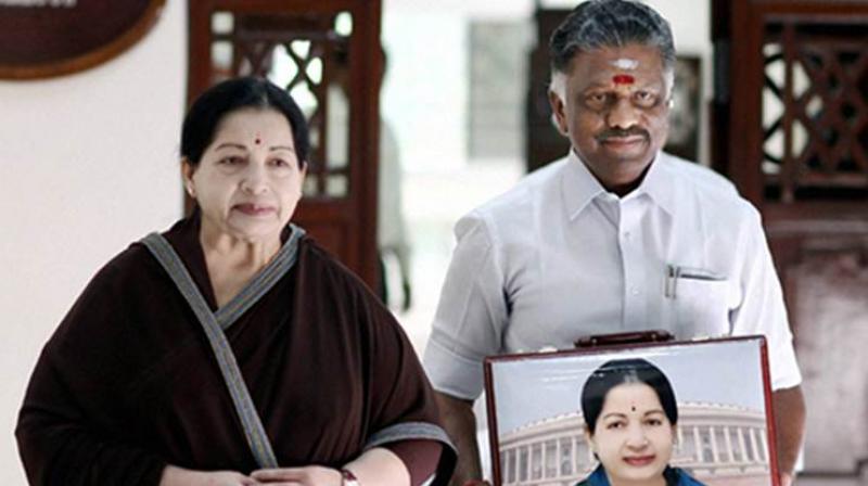 Tamil Nadu caretaker Chief Minister O. Panneerselvam with late CM J. Jayalalithaa (Photo: PTI/File)