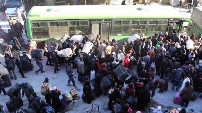 Families spent the night in freezing temperatures in bombed out apartment blocks in Al-Amiriyah district, which was the departure point for evacuations before they were halted on Friday. (Photo: AP)