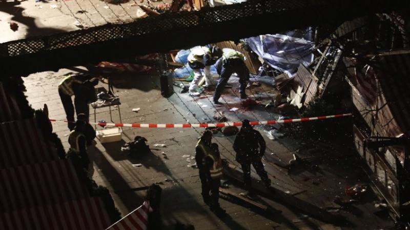 Twelve people were killed and almost 50 wounded, 18 seriously, when the lorry tore through the crowd, smashing wooden stalls and crushing victims. (Photo: AFP)