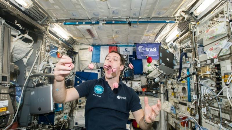 French astronaut Thomas Pesquet displays his juggling and eating skills during a light moment on the International Space Station (Photo: AFP)