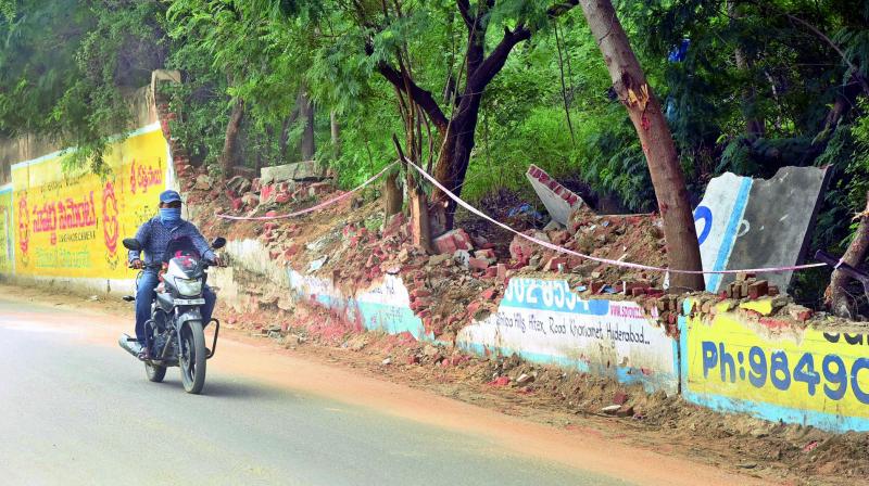 A motorist passes near the debris of the Lingampally reservoir wall that collapsed on Wednesday night. (Photo: DC)