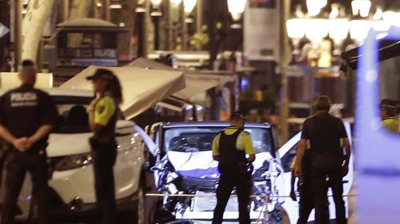Police officers stand next to the van involved on an attack in Las Ramblas in Barcelona, Spain, Thursday. (Photo: AP)