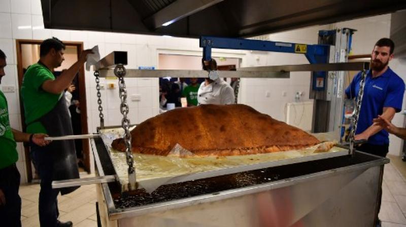Muslim Aid staff and volunteers cook the worlds largest samosa at the East London Mosque in London  (Photo: AFP)
