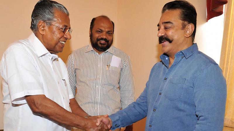 Chief Minister Pinarayi Vijayan greets actor- politician Kamal Hassan at Bolgatty Palace in Kochi on Sunday. (Photo: DC)