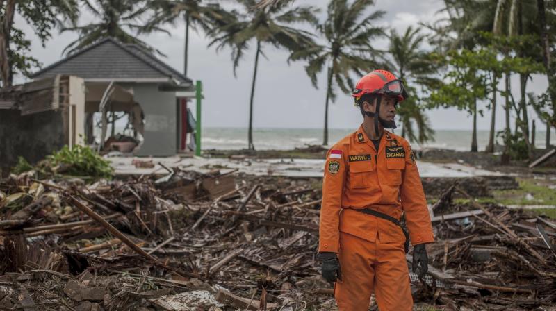 A rescuer stands amid debris at a tsunami-ravaged area in Carita, Indonesia, Sunday. (Photo: AP)