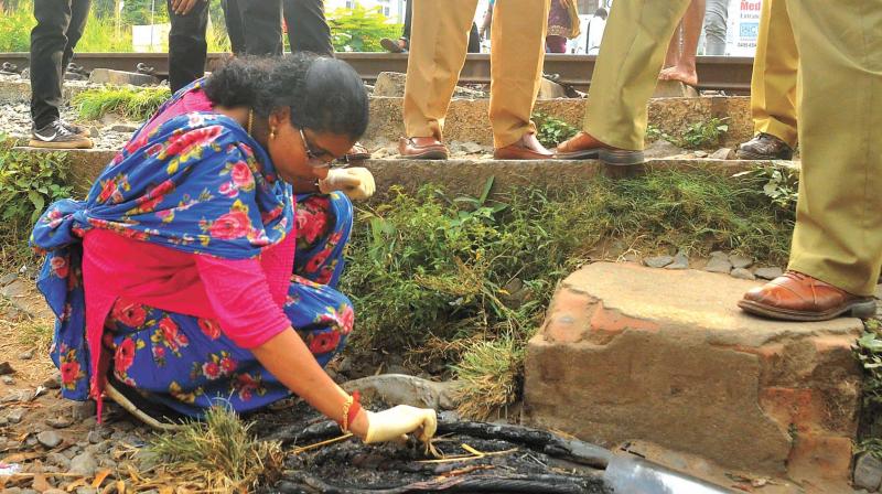 Scientific expert Mini V. collects remnants of the burnt cable behind Head Post Office in Kozhikode on Tuesday. (Photo:  DC)