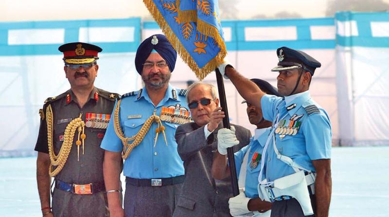 President Pranab Mukherjee presenting the Presidents Standard to 125 Helicopter Squadron and Colours to Mechanical Training Institute of Indian Air Force at Air Force Station, Tambaram, on Friday. He later released a special cover and brochure on the occasion. (Photo: DC)