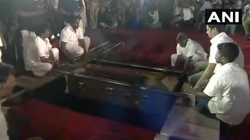 DMK chief M Karunanidhi being laid to rest at Marina Beach. (Photo: ANI)