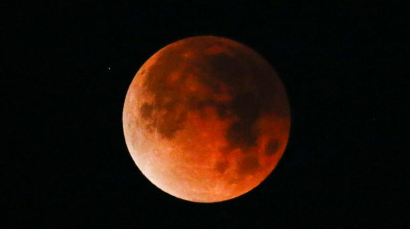 A rare celestial occurrence as a Super Blue Blood Moon is seen at Santa Monica Beach in Santa Monica, Calf. The moon is putting on a rare cosmic show. Its the first time in 35 years a blue moon has synced up with a supermoon and a total lunar eclipse. NASA is calling it a lunar trifecta: the first super blue blood moon since 1982. That combination wont happen again until 2037.