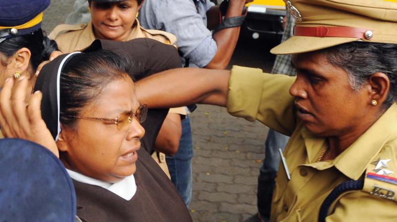 Police remove people protesting against the LPG Terminal at Puthuvype from the High Court Jn on Friday. 	(Photo: DC)