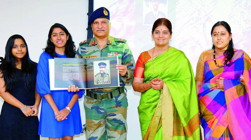 Aparajita, daughter of Maj. Padmapani Acharya (second from left), with Maj. Gen. N. Srinivas Rao, General Officer Commanding, Telangana Sub Area, as he releases a book commemorating her father. To Gen. Raos right is the Majors wife, Charu Latha.