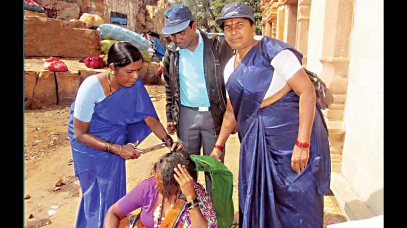 Seetavva Jodatti (left) cutting the hair of a Devadasi as a process of rehabilitation. (Photo: DC)