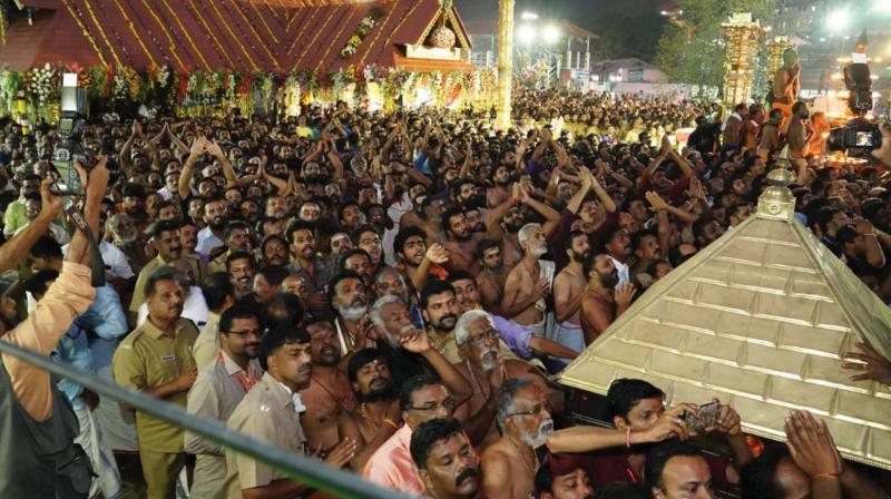 Devotees witness Makarajyoti at Sannidhanam on Monday.