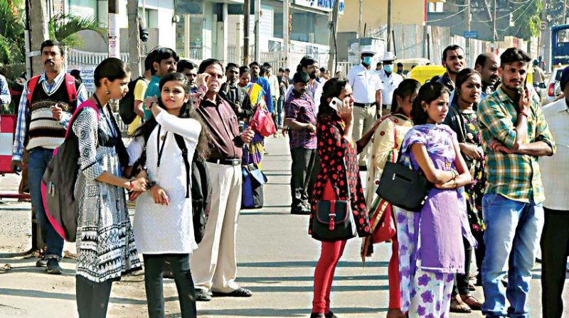 Commuters waiting for BMTC buses in Bengaluru on Wednesday, the second day of the two-day CITU strike 	 KPN
