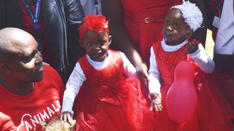 Former conjoined twins Blessing and Favor all pretty in red.(Photo: Facebook / Kenyatta National Hospital)