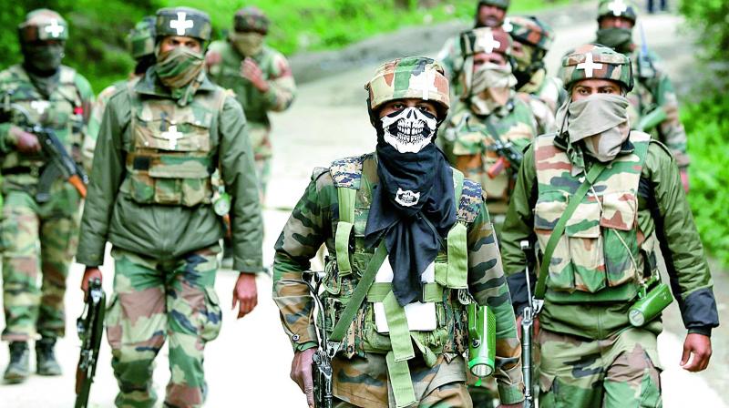 Soldiers walk back towards their base camp after a search operation in Shopian, about 60 km south of Srinagar, in Kashmir on Thursday. (Photo: AP)